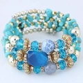 Bohemian multilayer bracelet featuring turquoise, crystal beads, and gold accents on white - Green