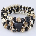Meerlaagse kralenarmband met zwarte natuursteen en gouden accenten in etnische stijl - Zwart
