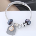 Macro shot of silver charm bracelet with galaxy glass beads and zircon pendant - Grey (0150805201)