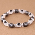 Macro detail of Hamsa Evil Eye beaded bracelet with hematite stones and silver spacers - White (015072660)