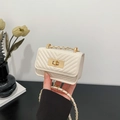Chic beige mini quilted crossbody bag with gold chain strap and elegant metal clasp - White