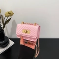 Mini light pink quilted crossbody bag with V-stitch pattern and gold chain strap - Pink