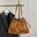 Glossy brown ruched tote bag with drawstring closure and silver bow charm detail - Brown