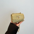 Mini gold chain crossbody bag with diagonal embossed texture and metal turn-lock - Gold