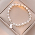 S925 silver pearl bracelet with rectangular tag and clover pendant on champagne velvet - S925 Silver Heart Desire Tag Freshwater Pearl Bracelet