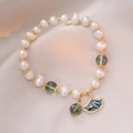 Baroque pearl bracelet with green gemstone beads and gold ginkgo leaf charm detail - Green Phantom Quartz Freshwater Pearl Bracelet