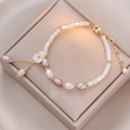 Elegant shell flower and freshwater pearl bracelet on champagne satin jewelry box - Shell Flower Freshwater Pearl Bracelet