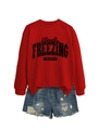Detail view of red 'literally FREEZING' sweatshirt paired with ripped denim shorts - S / Bright Red (Black Print)