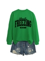 Detail of green sweatshirt with black text print paired with ripped denim shorts - Grass Green Sweatshirt (Black Pattern) / S