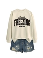 Detail of loose cream sweatshirt with literally freezing print and distressed blue denim shorts - S / Tops / Sand
