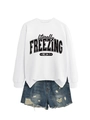Close-up of white sweatshirt with 'literally FREEZING' print and distressed denim shorts - S / Tops / White