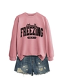 Detail of pink cotton sweatshirt with 'literally FREEZING' print and ripped denim shorts - S / Tops / Rose Gold (Black Print)