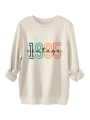 Dettaglio della stampa vintage 1985 su felpa beige che mostra la trama del tessuto - S / Sabbia