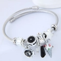Adjustable stainless steel charm bracelet featuring starfish and crystal beads - Black