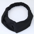 Close-up of black ribbed knit headband showing the twist knot and vertical texture - Black