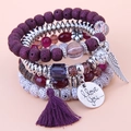 Detail of bohemian layered beaded bracelet with purple tassel and silver wing charm - Purple Character