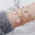 Elegante set de 4 pulseras doradas con nudo, colgante de corazón y strass brillante - Dorado