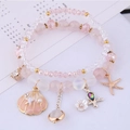 Armband-Set mit Seestern- und Muschelanhängern, rosa Perlen und goldenen Details - Flesh
