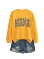 Detailed view of yellow MAMA sweatshirt with camouflage print and ripped denim shorts - S / Yellow