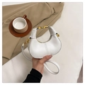 Primer plano de bolso media luna blanco en cuero con herrajes dorados y textura fina - Blanco