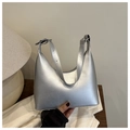 Close-up of metallic silver crescent bag with adjustable shoulder strap and buckle - Silver