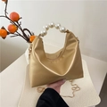 Elegant champagne gold handbag with large pearl handle and chic gold chain strap - Gold