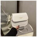 Detail of white PU leather saddle bag featuring houndstooth texture and gold buckle - White