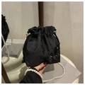 Detailed view of black satin bucket bag with 3D butterfly embroidery and pearl chain - Black