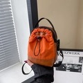 Minimalist drawstring crossbody bucket bag with orange nylon and brown leather contrast - Orange