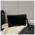 Detail view of black glossy leather envelope bag with gold hardware and wristlet strap - Black