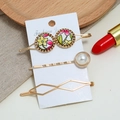Three-piece golden hair clip set with floral patterns and pearl on a display card - Multicolor (0190508103)