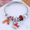 Detail of adjustable stainless steel charm bracelet with red crystals and swan pendant - Red