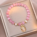 Pink cat eye stone and freshwater pearl beaded bracelet with a gold money bag charm - Pink Money Bag Style (TS0181)