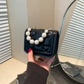 Mini black crossbody bag with heart quilting and oversized pearl handle detail - Black