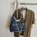 Blue denim hobo bag with sequin details and a white bow accent on a metal hanger - White
