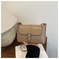 Close-up of beige vintage crossbody bag showing textured faux crocodile leather and buckle - Khaki
