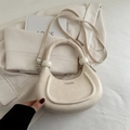Minimalist beige crescent shoulder bag with unique ball clasp and adjustable strap - White