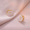 Elegant gold daisy stud earrings with pink petals and zircon center on pink silk fabric - Rotating Daisy Stud Earrings (E0878)