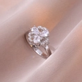 Silver-toned clover ring with sparkling teardrop zircons on a champagne satin background - Three-petal Flower Ring(J0040) / Steel