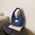 Dark blue denim handbag featuring white heart patterns and a cartoon bear patch - Blue