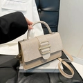 Chic beige crossbody bag with sequin flap and gold buckle on a stylish chair setup - Khaki
