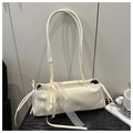 Detail of cream white faux leather bag with delicate lace strap and ribbon bow decoration - White