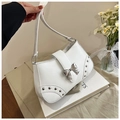 Detailed shot of white leather shoulder bag featuring silver bow buckle and rivet accents - White