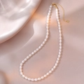 Macro detail of natural freshwater pearls with S925 silver heart tag on gold chain - Creamy White Style (YX0060) / Approx. 5.0mm Pearl