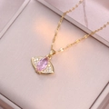 Fashionable gold necklace with a pink eye pendant and micro-pave diamonds on a jewelry box - Pink