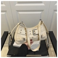 Close-up of cream shoulder bag with metallic buckle details and silver eyelets on leather - Khaki