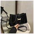 Detail of the black pleated texture surface and the golden H-shaped buckle on the shoulder bag - Black