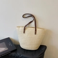 Beige straw tote bag with brown leather handles and vintage rivets on a white background - Simple Style / Off White
