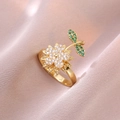 Golden sunflower open ring with white and green crystals on pink fabric backdrop - Sunflower Rotating Ring (J0328)
