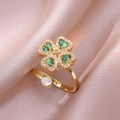 Close-up of a gold clover ring with green cubic zirconia and sparkling white crystals - Emerald Green Heart Rotating Ring (J0323)